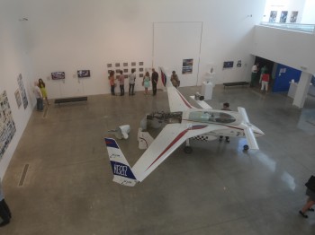 An early XCOR rocketship and several rocket engines are the central attraction of the art show.
