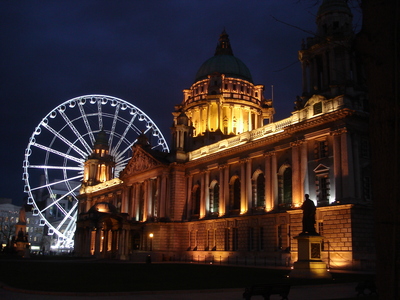 City hall and ferris at night.